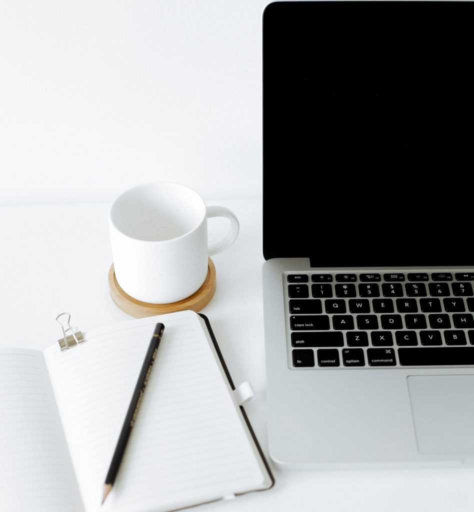desk top with notebook and laptop